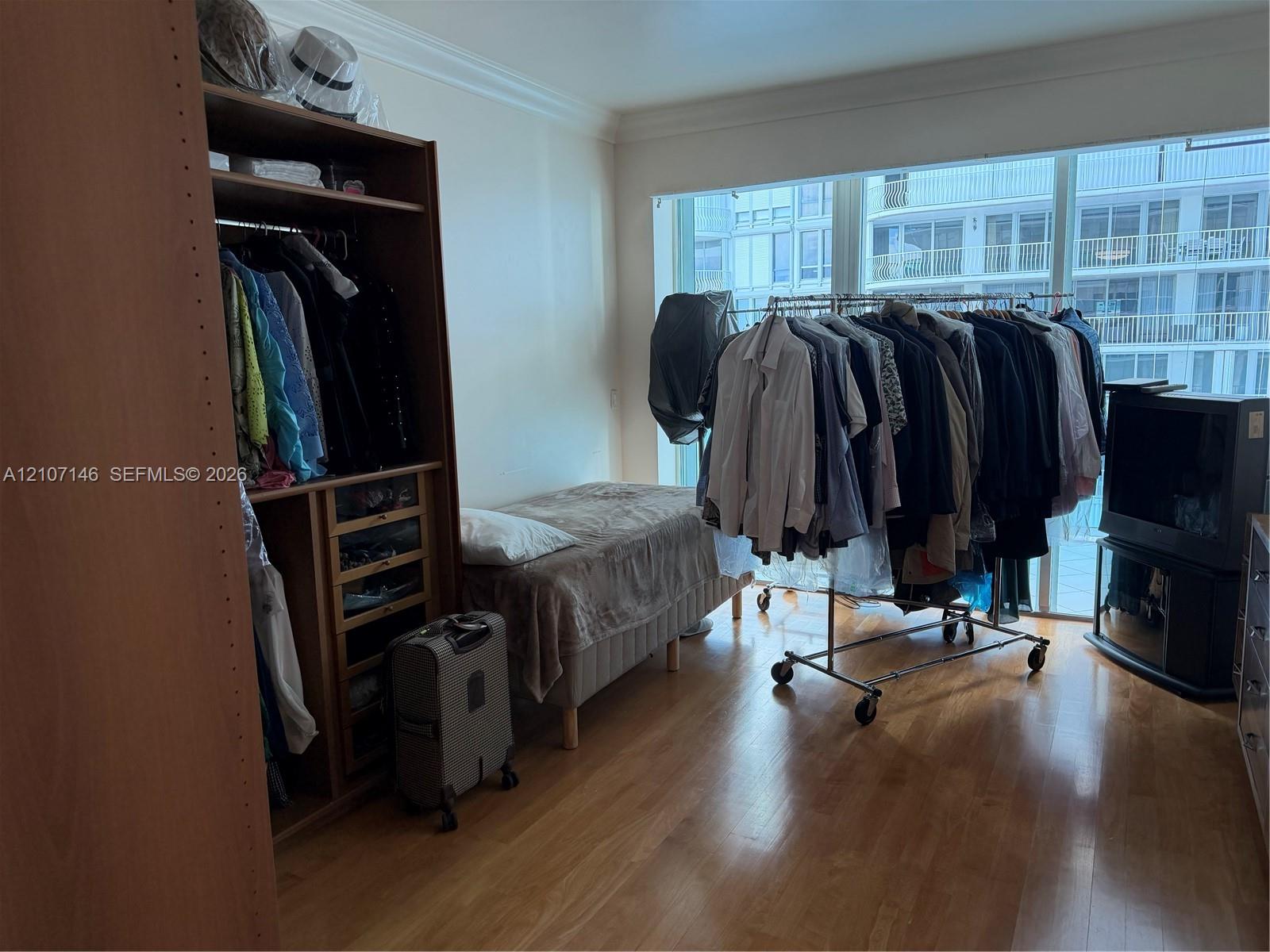 Large floor-to-ceiling windows featuring expansive natural lighting and wood-finish flooring