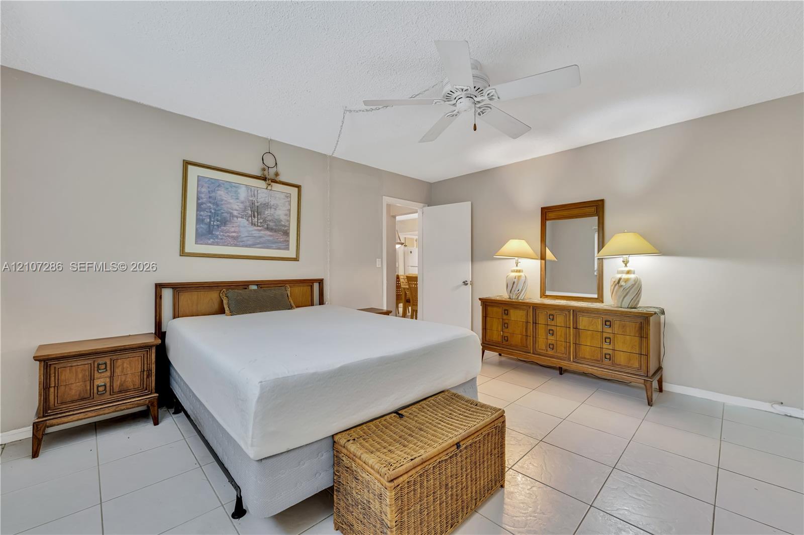 Neutral wall tones, ceramic tile flooring, and a central ceiling fan