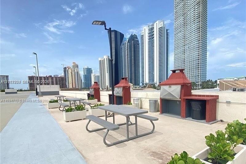 Outdoor terrace featuring built-in masonry grilling stations and integrated concrete planters