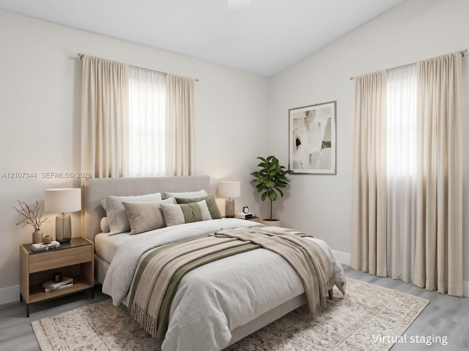 Neutral-toned interior space featuring vaulted ceilings, wood-finish flooring, and multiple windows