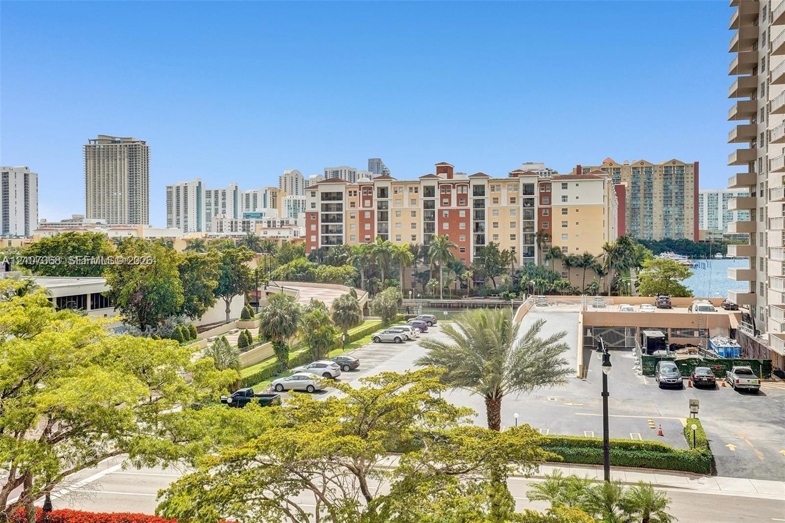 Elevated perspective featuring mature palms, manicured landscaping, and expansive urban scenery