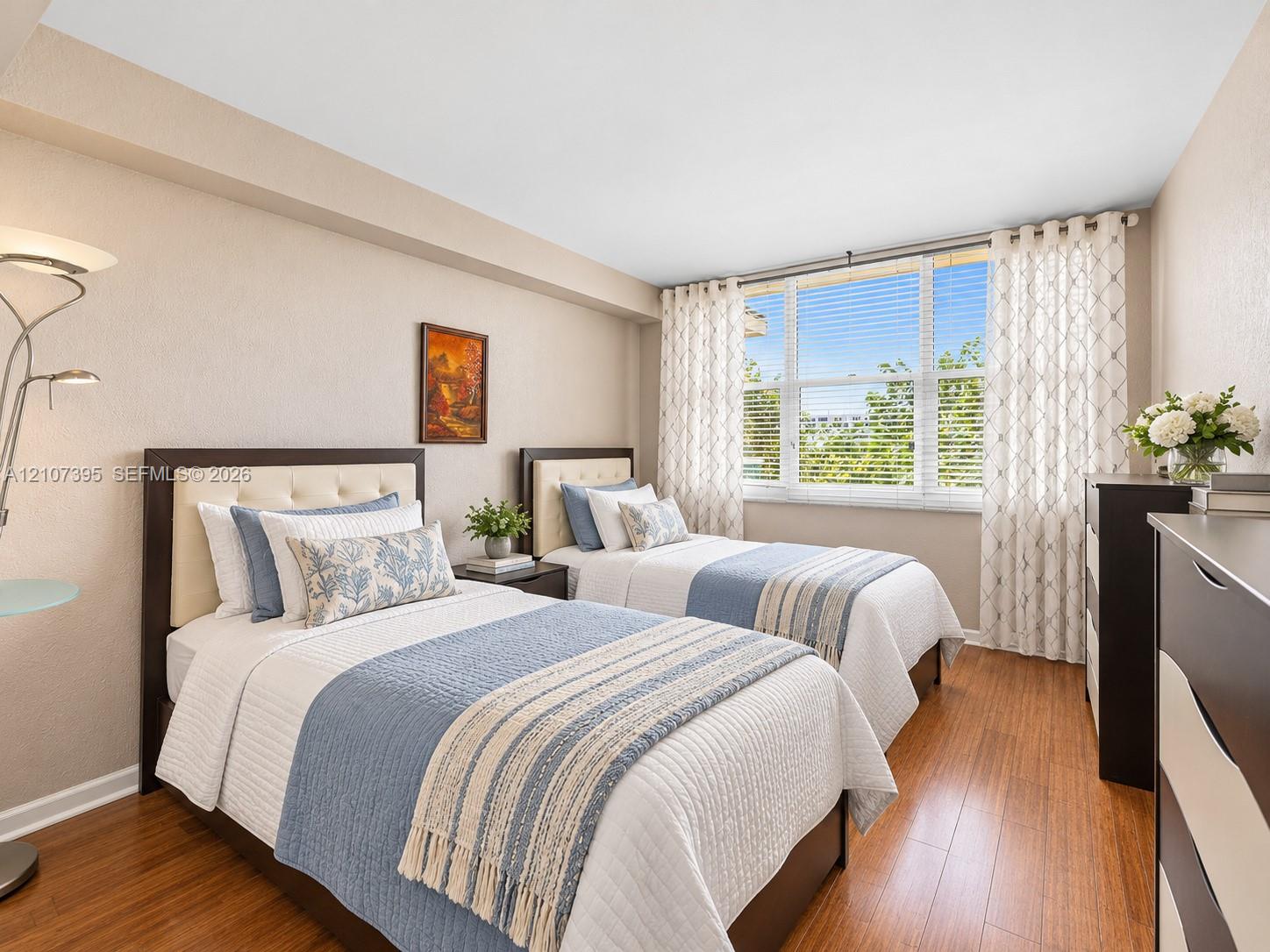 Wood-finish flooring and a large, multi-panel window allowing natural light