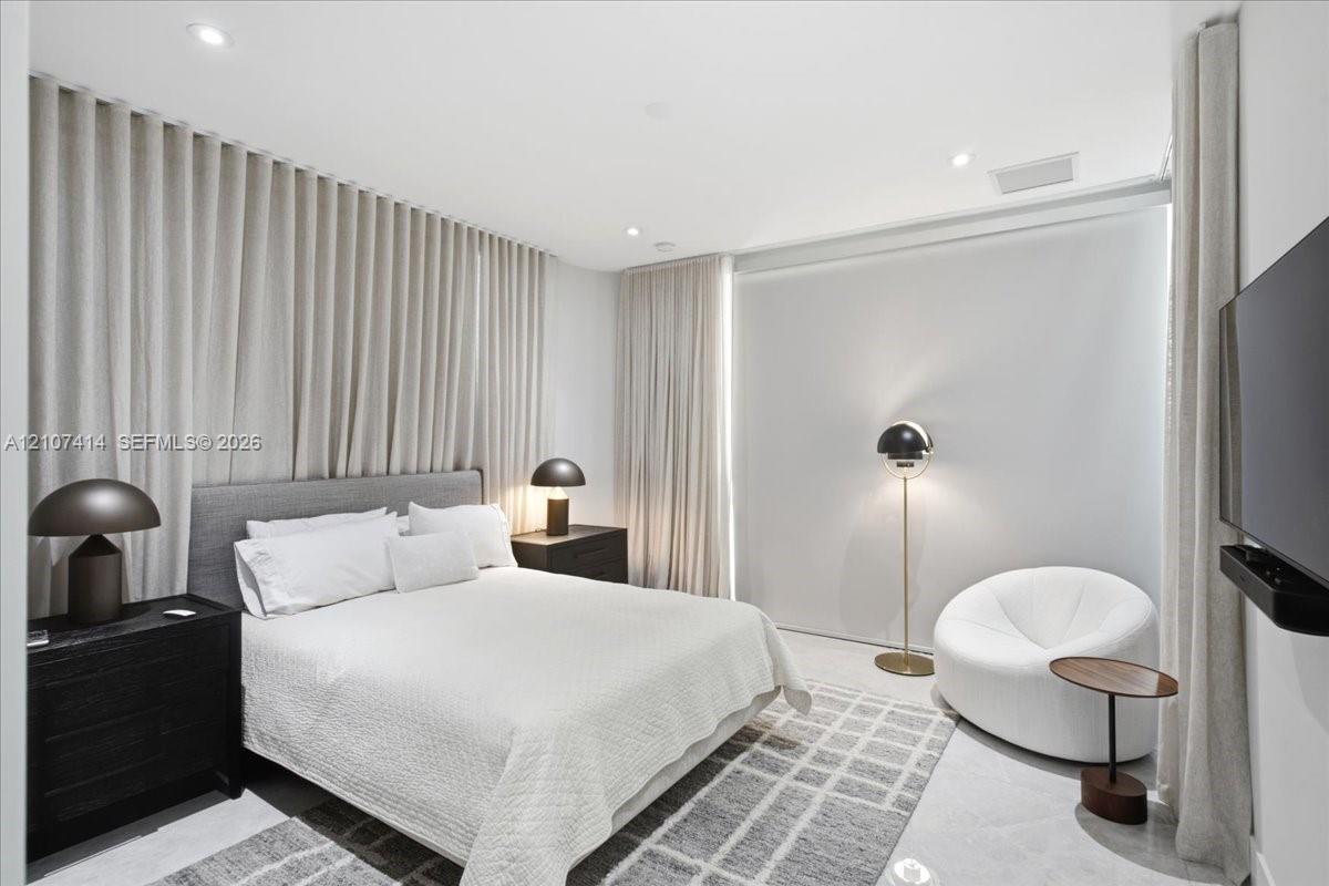 Wall-to-wall floor-to-ceiling drapery, recessed ceiling lighting, and smooth surface flooring