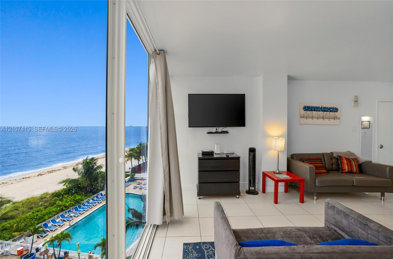 Floor-to-ceiling glass wall, ceramic tile flooring, and direct coastal scenery