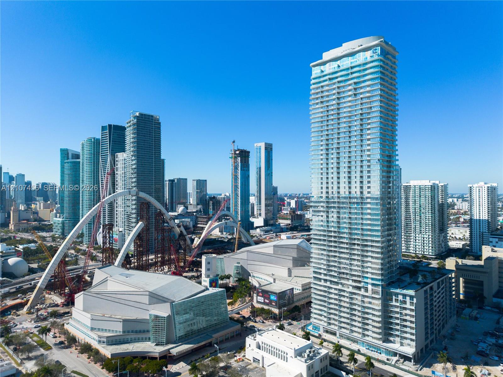 High-rise tower featuring glass-paneled exterior walls and stacked cantilevered balconies