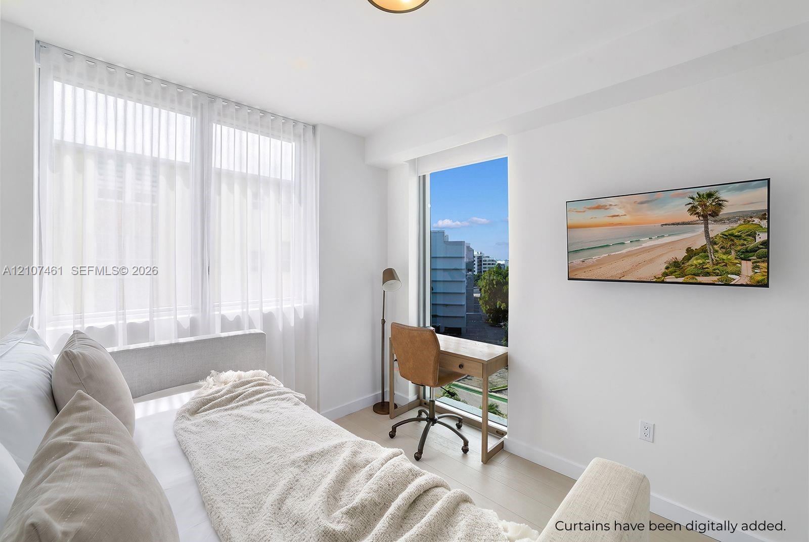 Neutral interior featuring large-format windows, light-toned wood-finish flooring, and recessed ceiling lighting