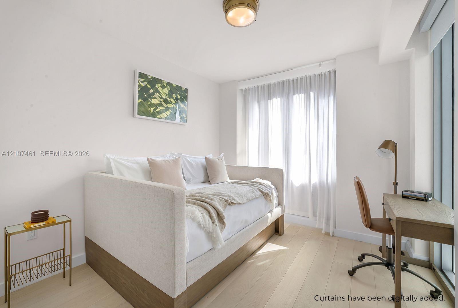 Light-toned wood-finish flooring, floor-to-ceiling windows, and brass-finish flush mount lighting