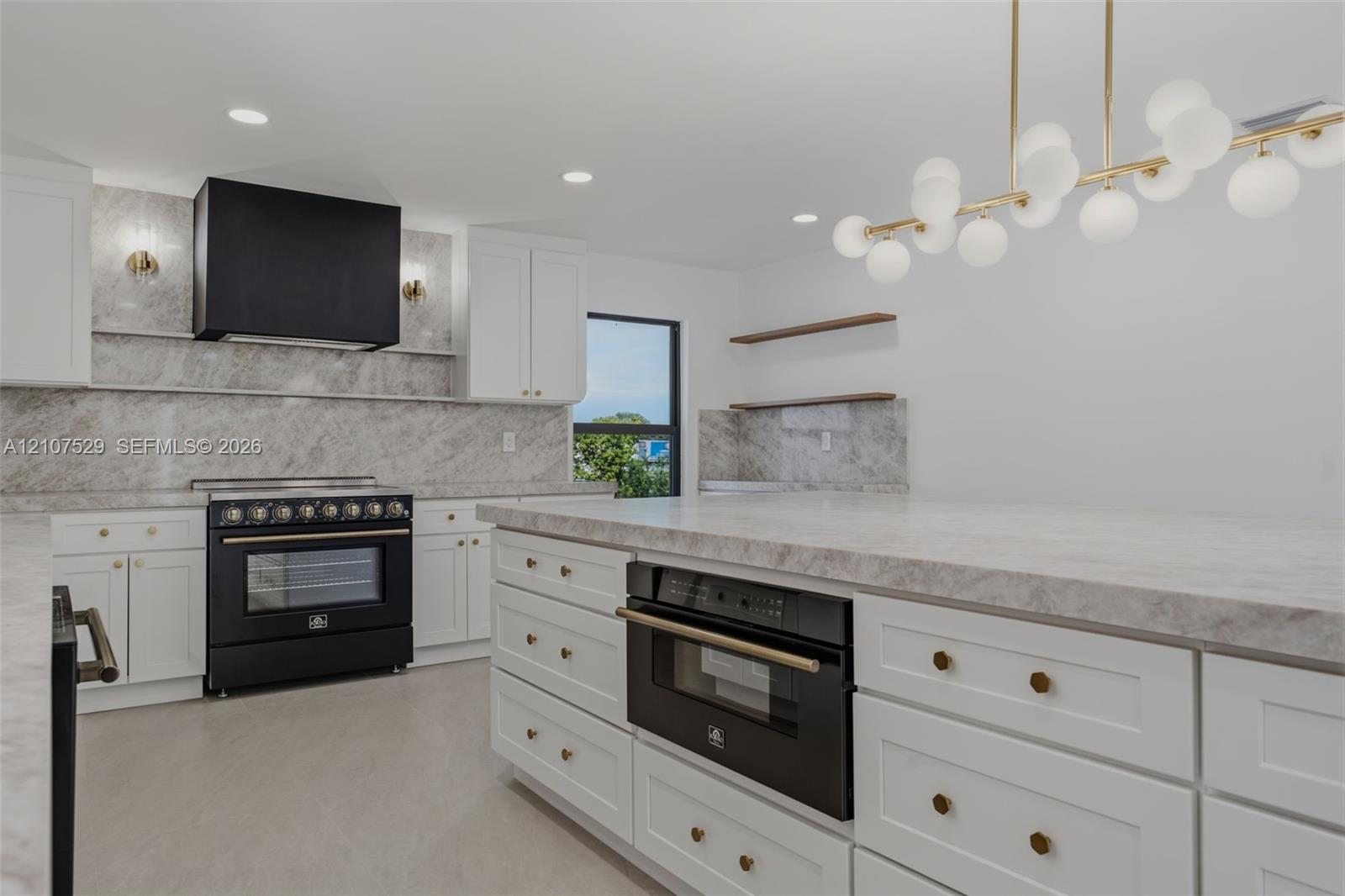Kitchen featuring white cabinetry, stone-surface countertops, full-height stone backsplash, matte black appliances, and recessed lighting