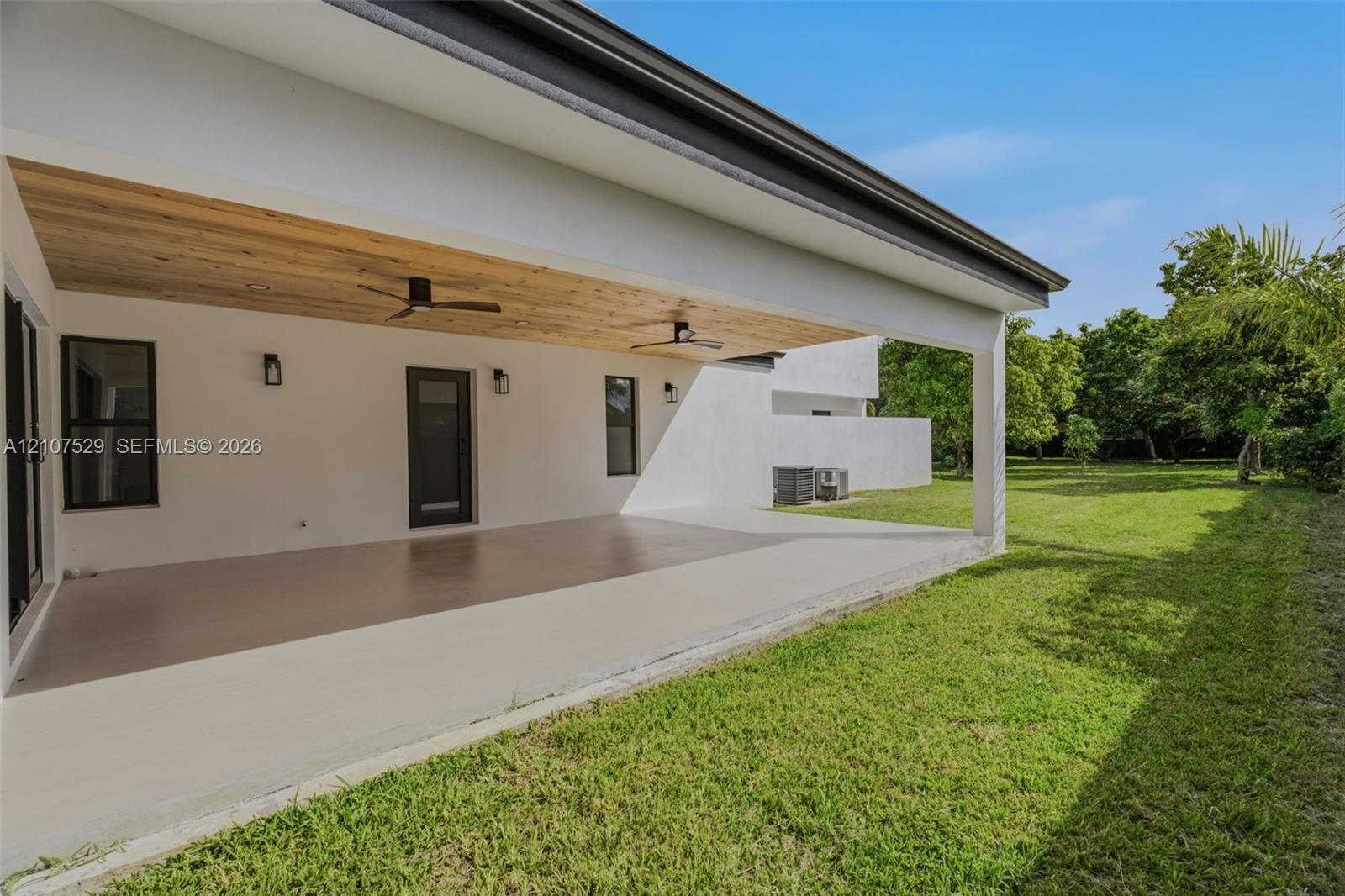 Covered patio featuring a wood-plank ceiling, recessed lighting, ceiling fans, and concrete flooring