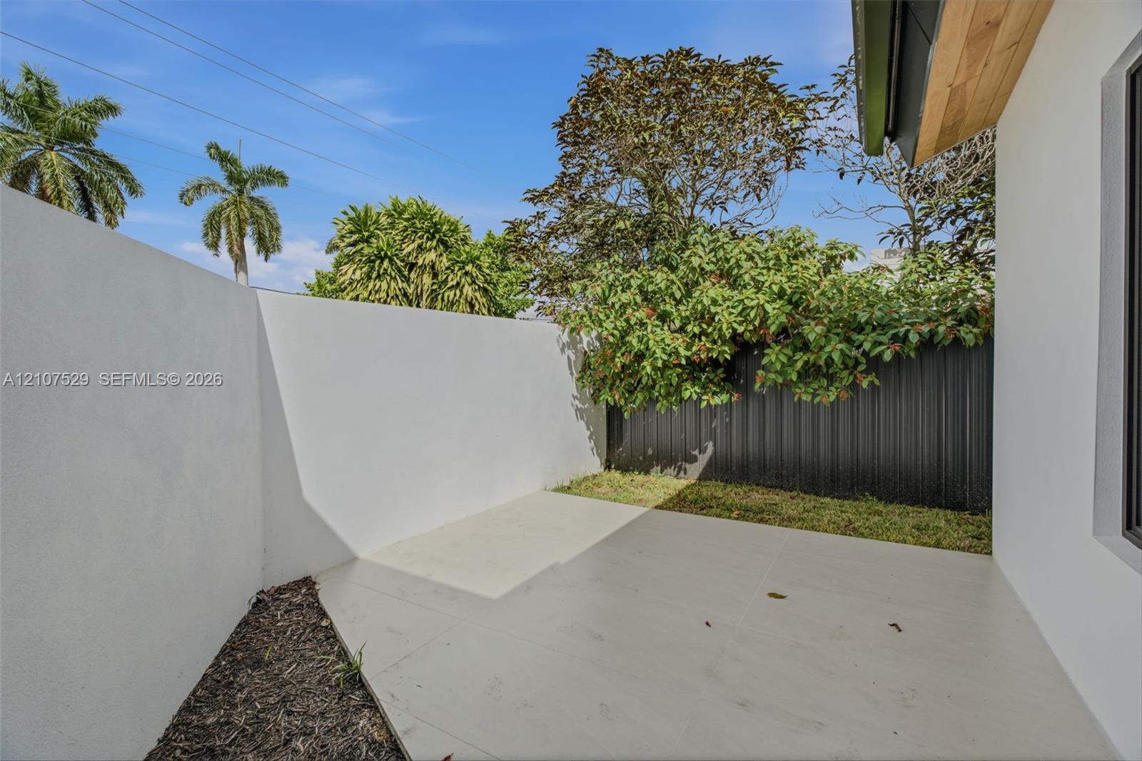 Vaulted ceilings featuring recessed lighting and a multi-arm chandelier, large-format tile flooring, oversized picture windows, and double-entry doors with geometric glass insets