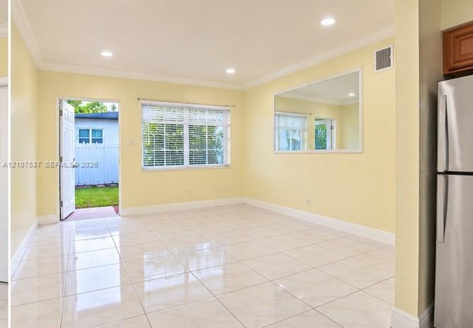 Glossy tile flooring, recessed ceiling lighting, a large wall-mounted mirror, and a multi-lite glass panel door Glossy tile flooring, recessed ceiling lighting, a large wall-mounted mirror, and a multi-lite glass panel door