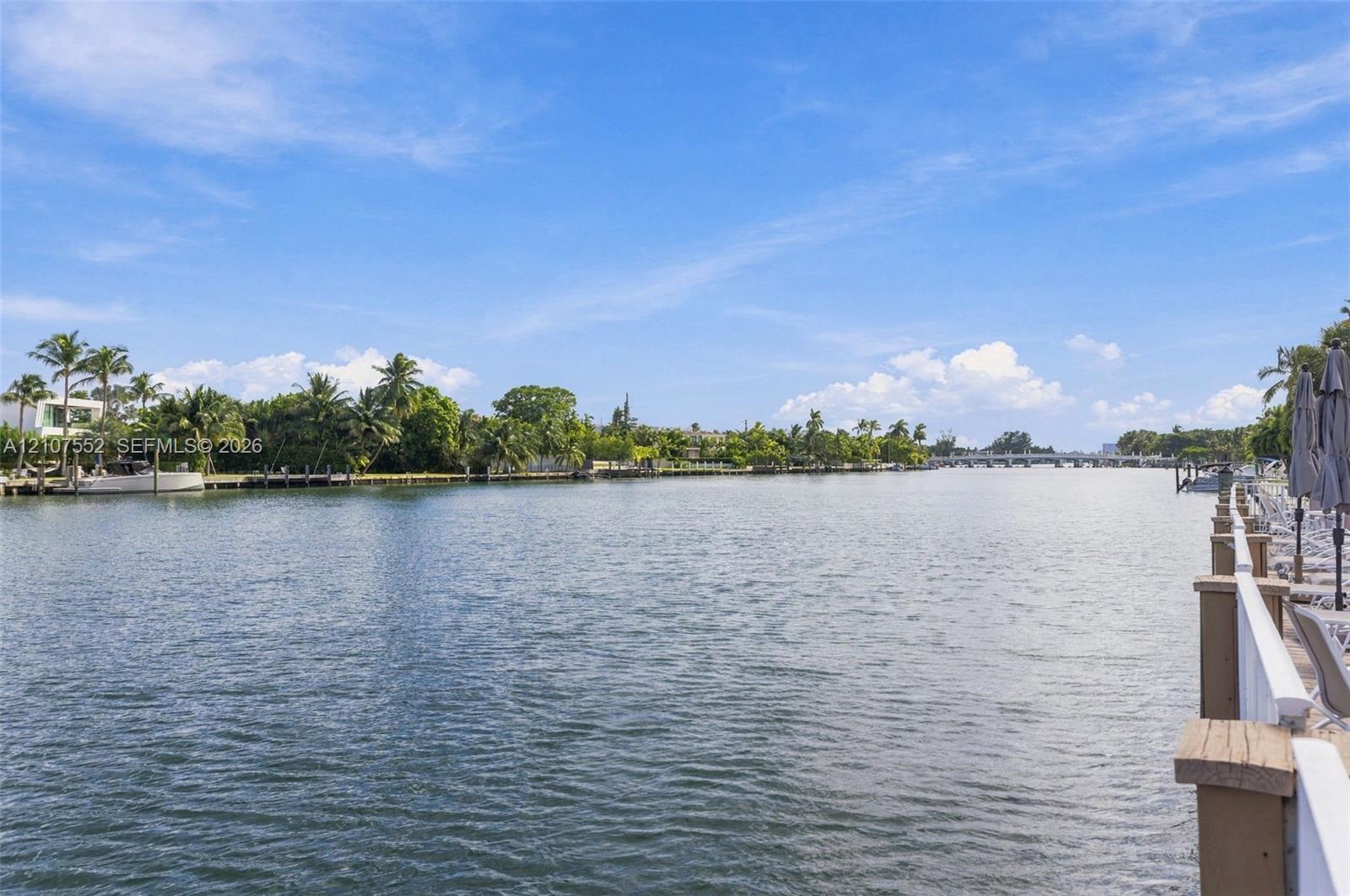 Waterfront property featuring a private bulkhead, expansive water frontage, and native palm trees