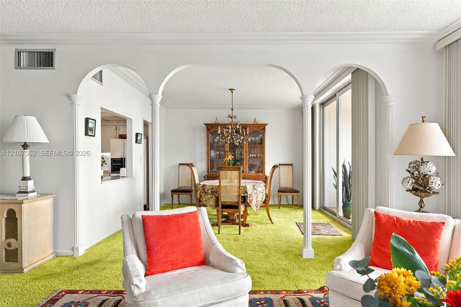 Interior space featuring decorative architectural archways with columns and sliding glass doors