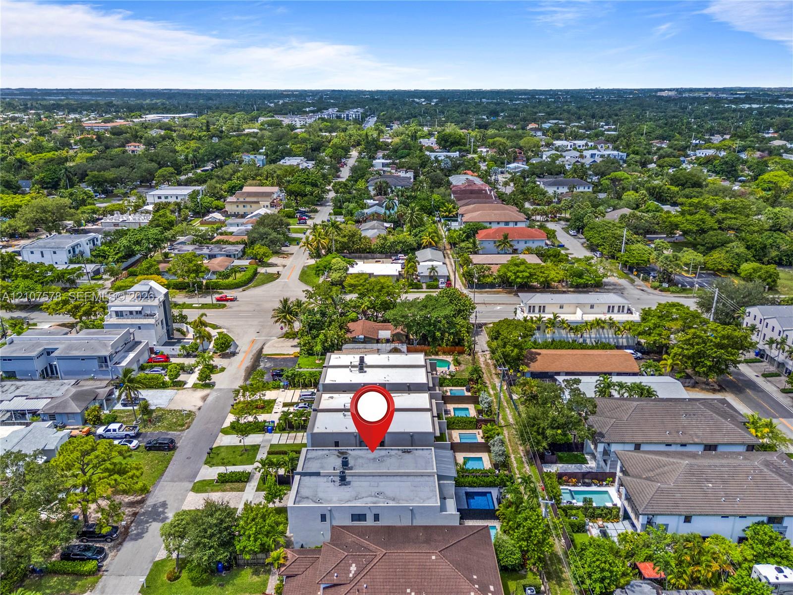 Aerial perspective of a multi-unit property featuring flat roofs and individual rear-set swimming pools