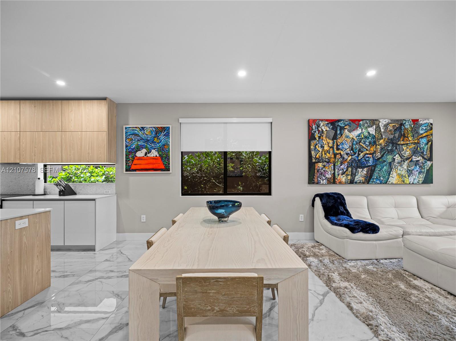 Kitchen featuring wood-finish cabinetry, white slab cabinetry, stone-finish flooring, and recessed ceiling lighting