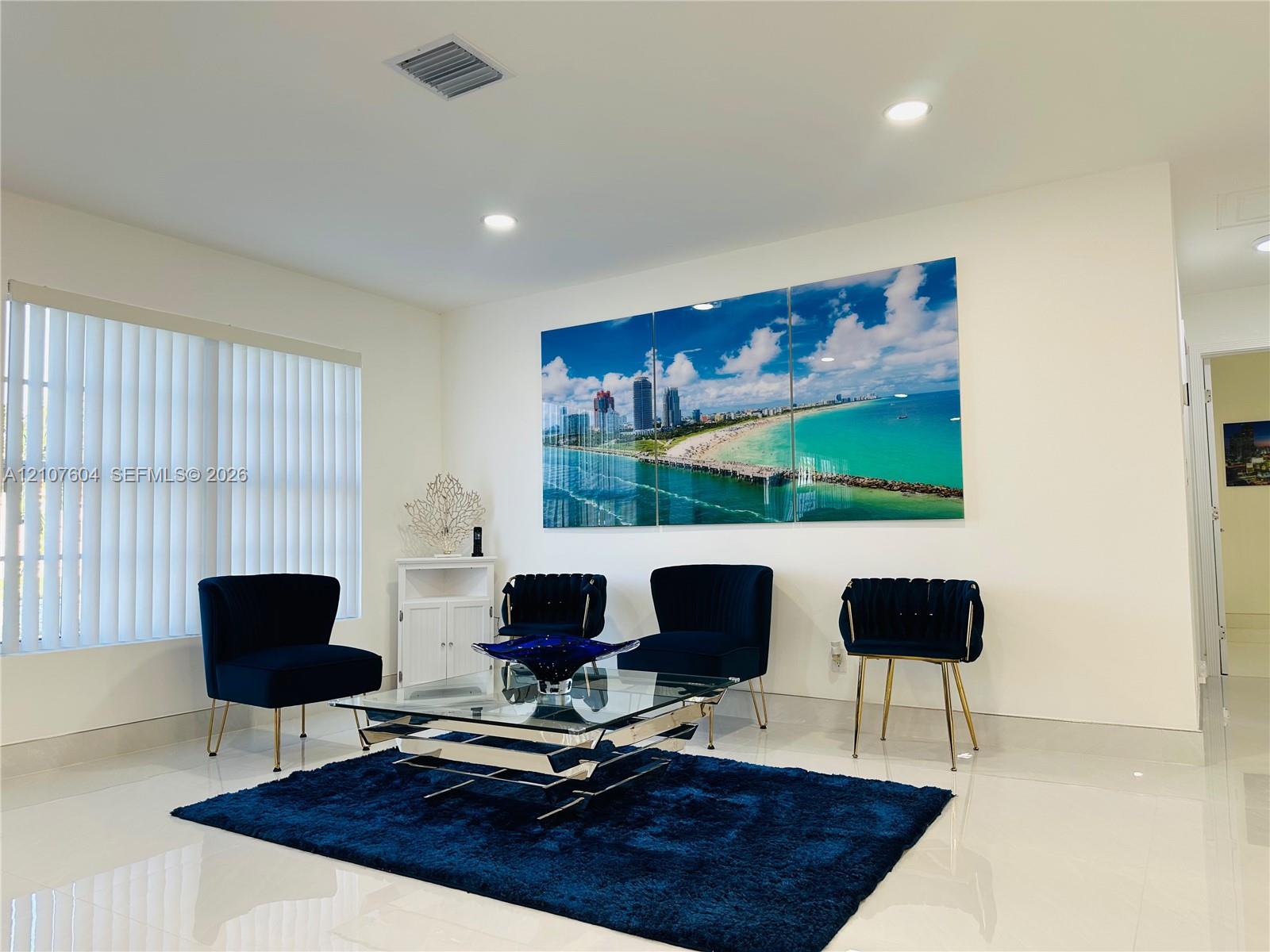 Interior space featuring polished tile flooring, recessed lighting, and vertical window blinds