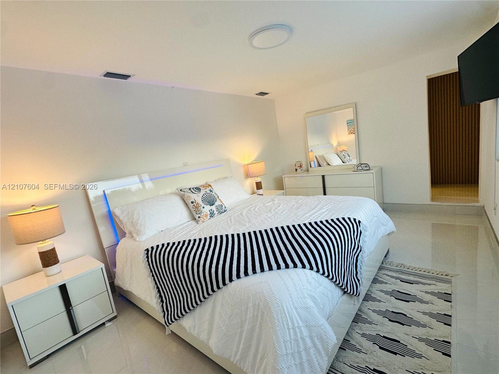 High-gloss tile flooring and recessed ceiling lighting