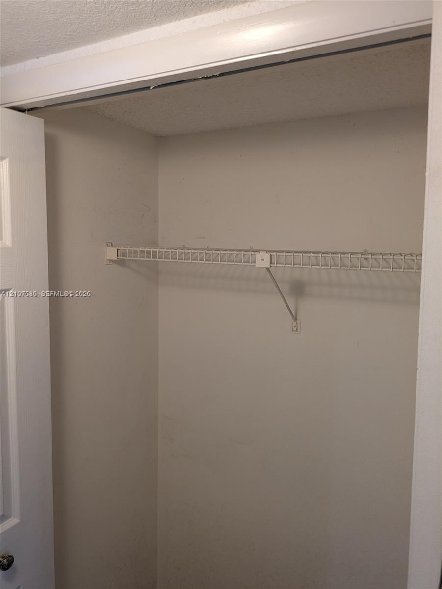 Closet featuring a white paneled door and installed wire shelving