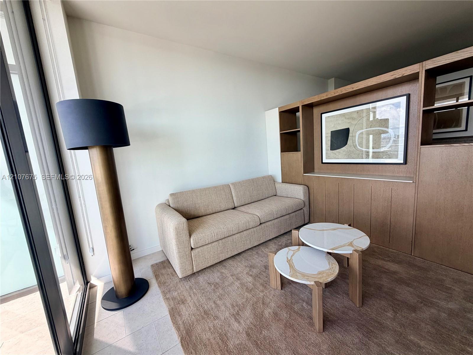 Built-in floor-to-ceiling wood cabinetry with integrated shelving and light-toned tile flooring