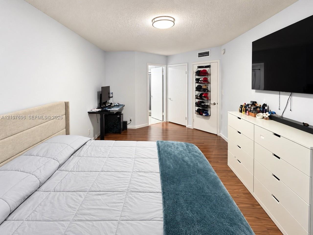 Wood-finish flooring, flush-mount ceiling lighting, and solid-core interior doors