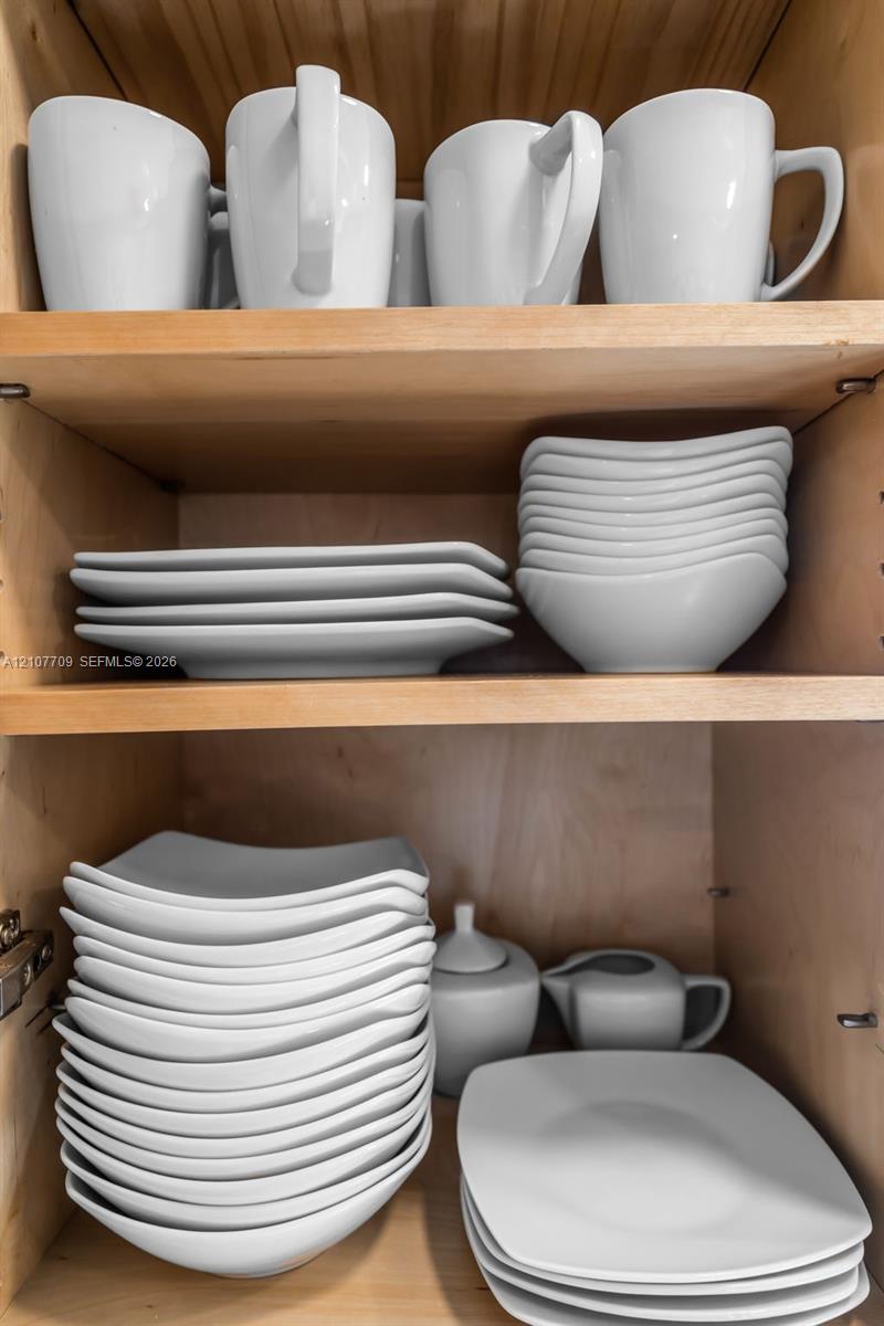 Natural wood-finish cabinetry featuring adjustable shelving and recessed metal hinge hardware