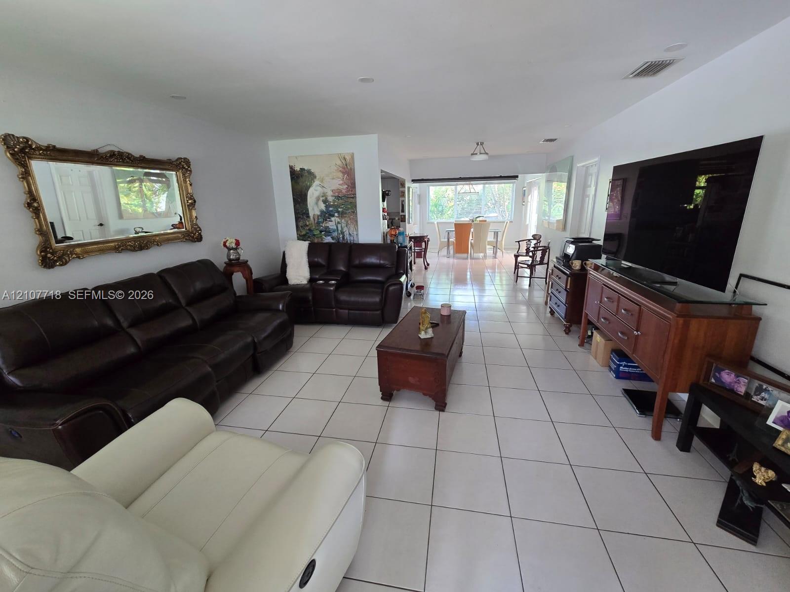 Open-concept interior featuring large-format ceramic tile flooring, recessed lighting, and expansive windows Open-concept interior featuring large-format ceramic tile flooring, recessed lighting, and expansive windows