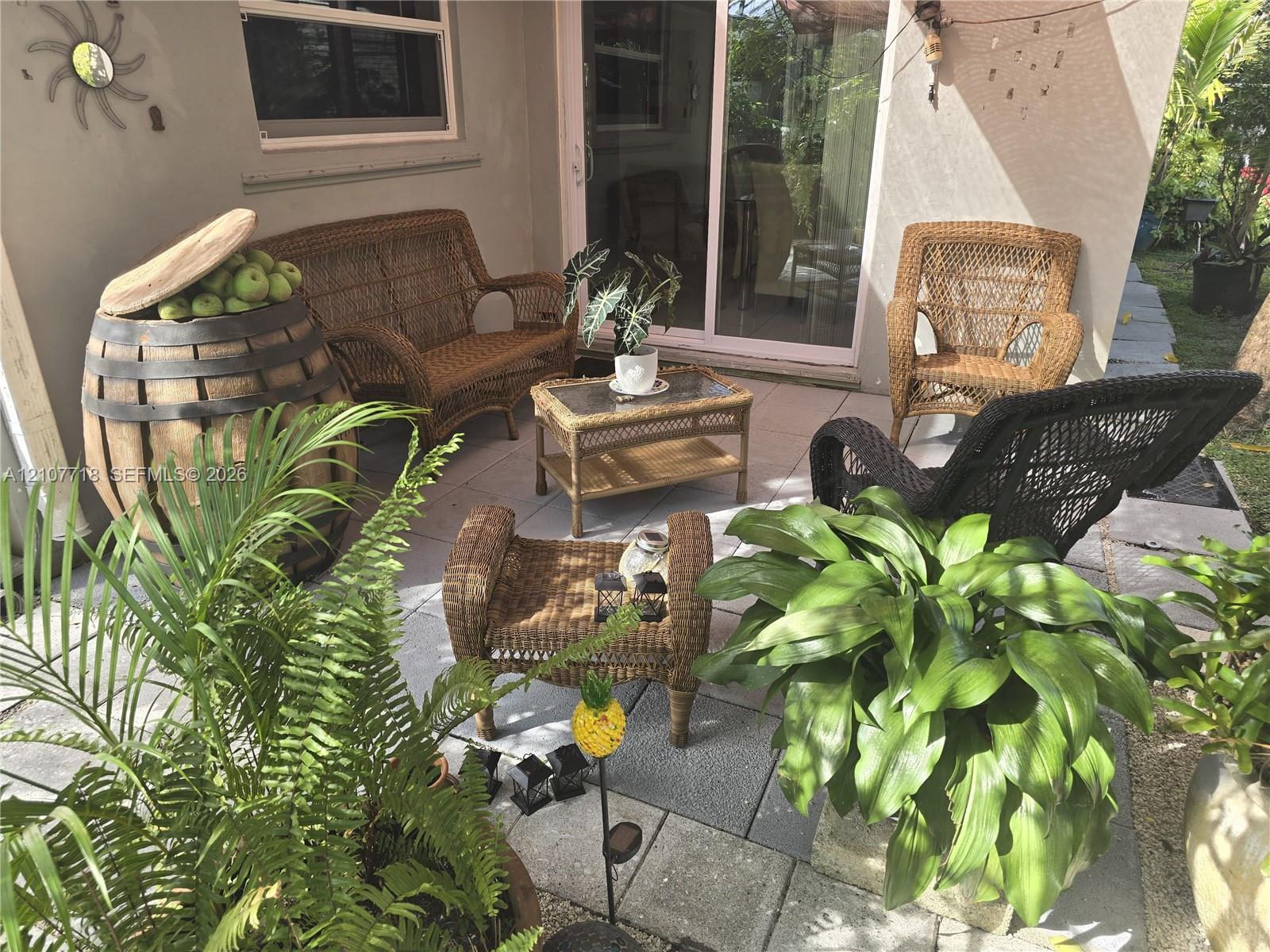 Paved patio featuring large-format concrete tiles and a sliding glass door Paved patio featuring large-format concrete tiles and a sliding glass door