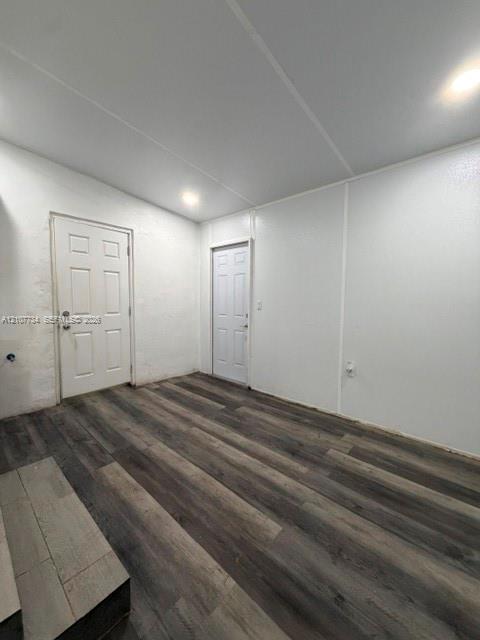 Interior space featuring wood-finish flooring, white walls, and recessed lighting