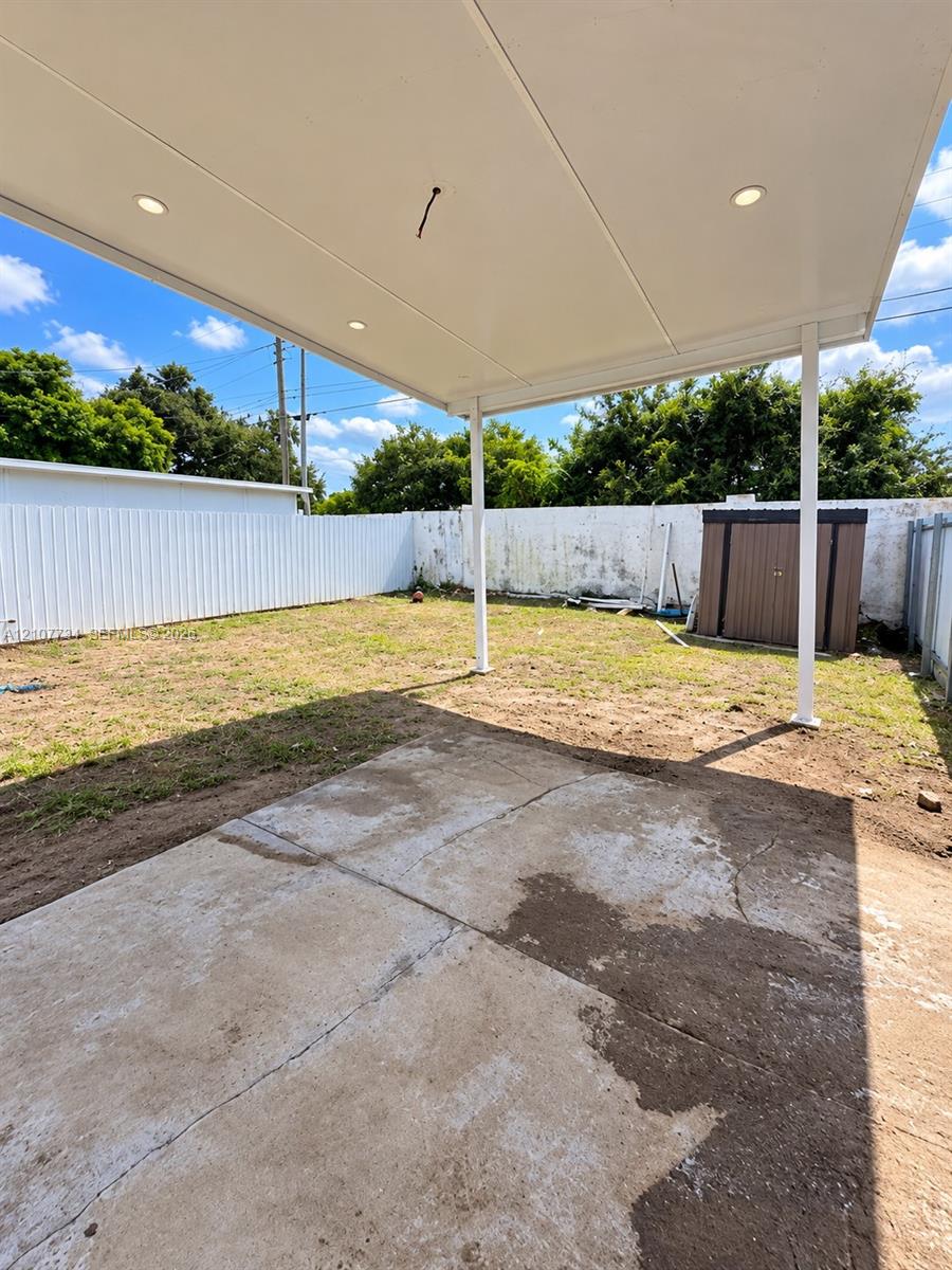 Covered patio featuring a concrete slab and recessed lighting, set within a fenced backyard Covered patio featuring a concrete slab and recessed lighting, set within a fenced backyard