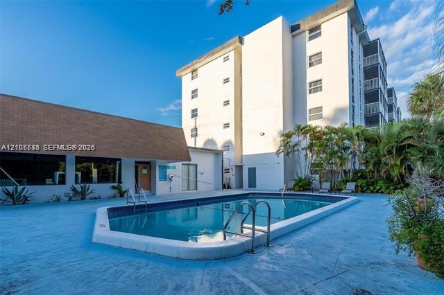 Swimming pool featuring a concrete deck and stainless steel handrails Swimming pool featuring a concrete deck and stainless steel handrails