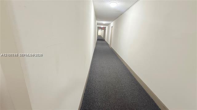 Hallway featuring neutral wall finishes, carpeted flooring, and recessed ceiling lighting