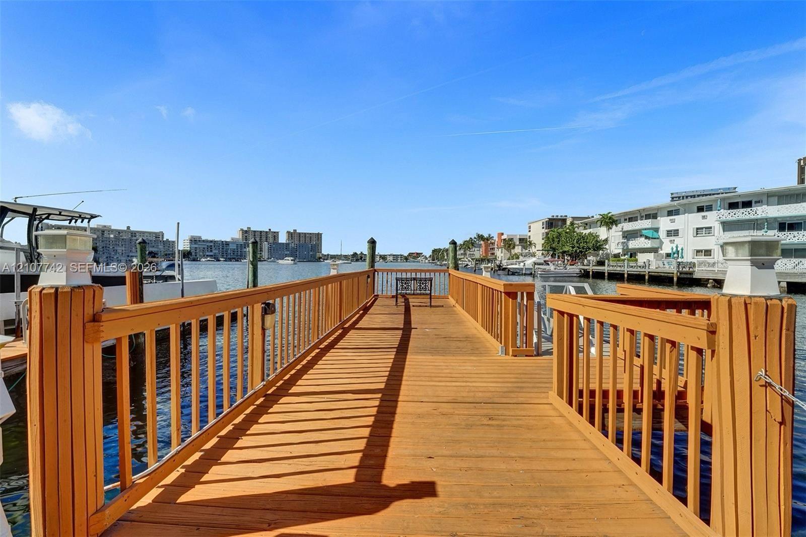 Private wooden dock featuring vertical post railings and integrated lighting