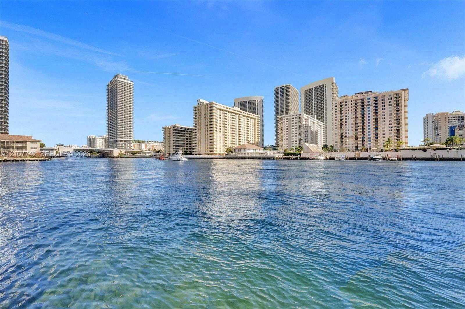 Waterfront location featuring direct access to the waterway, a bulkhead along the shoreline, and proximity to high-rise structures