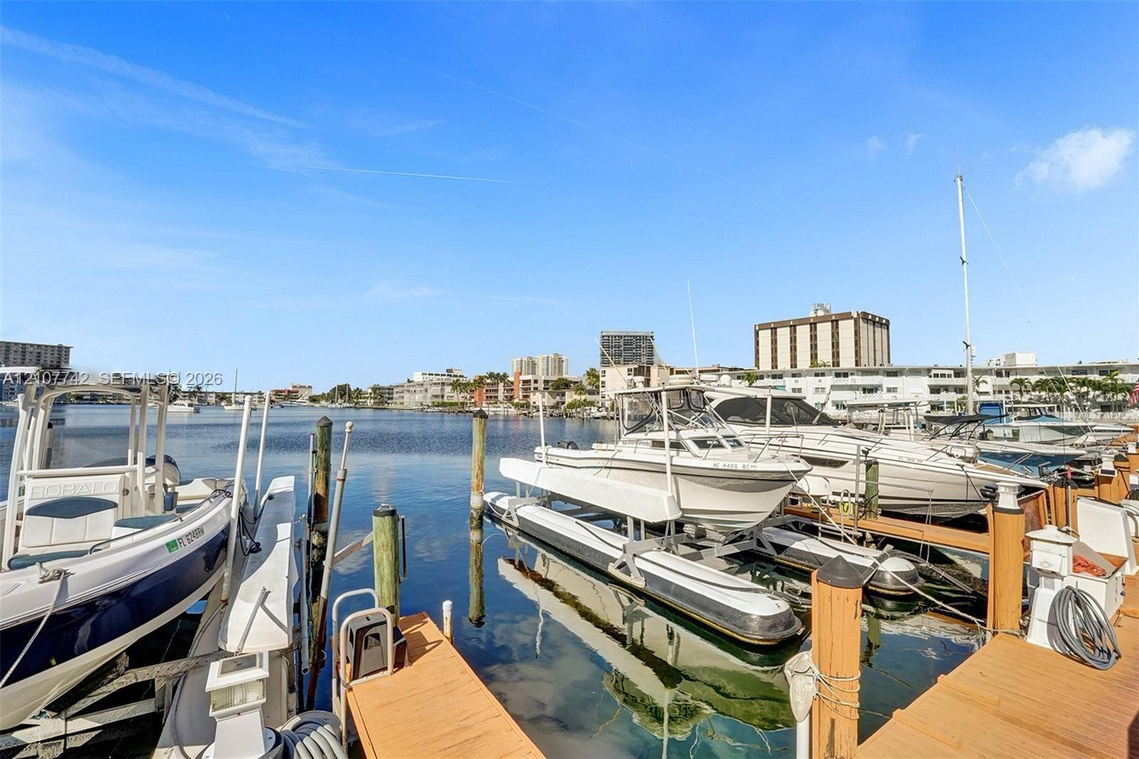 Private deep-water boat slips featuring wooden decking, vertical pilings, and mechanical boat lifts