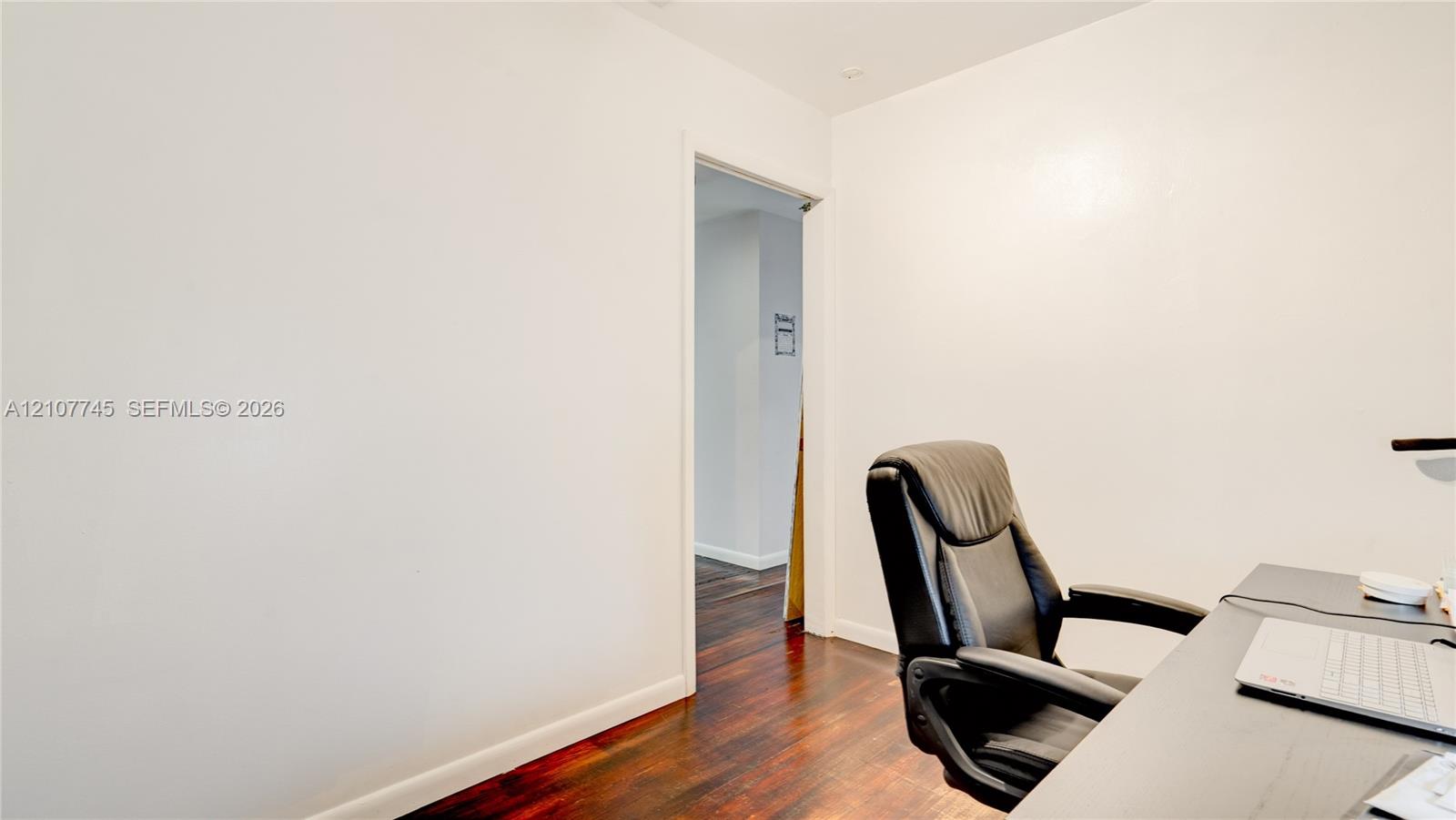 Interior space featuring wood-finish flooring and neutral-toned wall paint