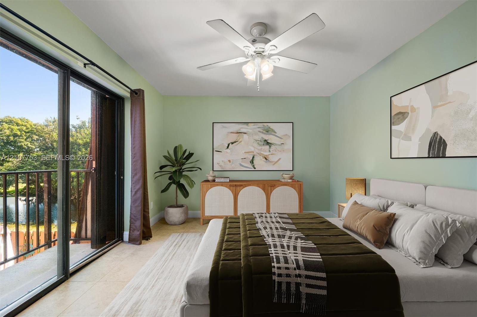 Sliding glass doors, exterior balcony with metal railing, and ceiling-mounted light fixture with integrated fan