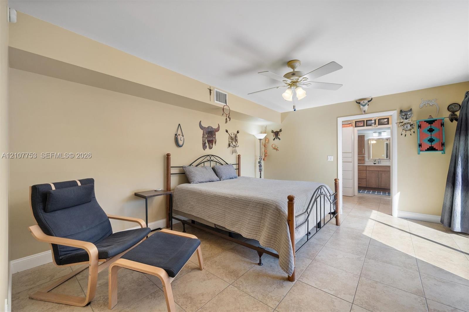 Neutral-toned room featuring large-format tile flooring, recessed ceiling lighting, and a central ceiling fan