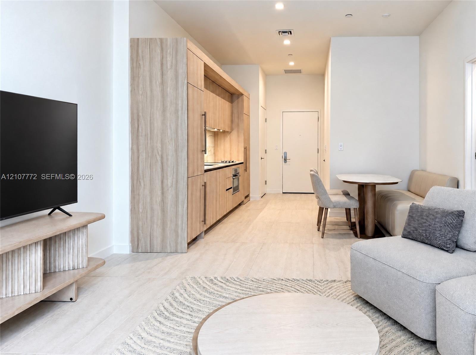 Kitchen featuring flat-panel wood-finish cabinetry, integrated appliances, and recessed lighting throughout Kitchen featuring flat-panel wood-finish cabinetry, integrated appliances, and recessed lighting throughout