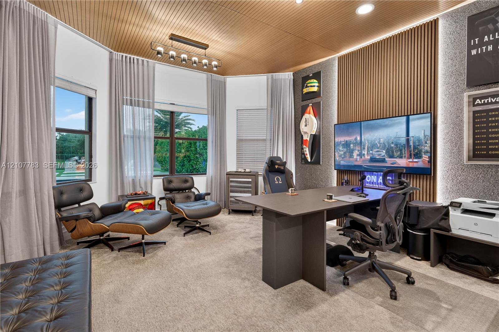 Curved wood-slat ceiling, vertical wood-slat feature wall with integrated LED accent lighting, multi-pane windows, and linear overhead pendant lighting