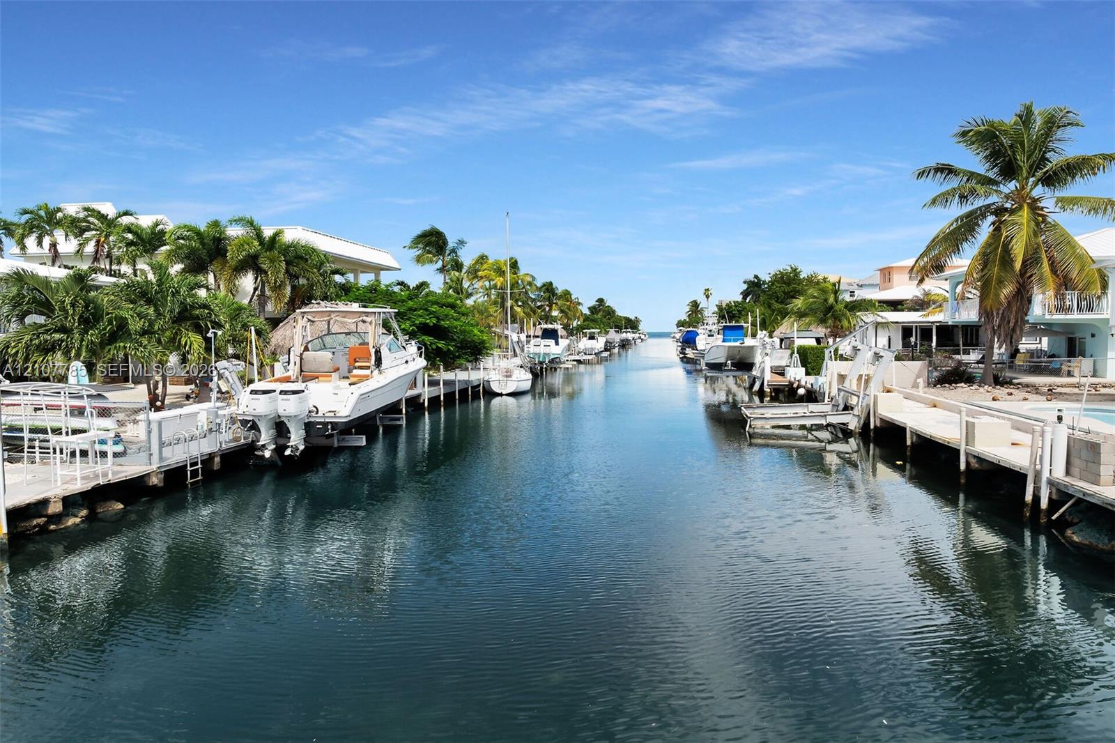 Waterfront canal featuring private boat docks and bulkhead seawalls