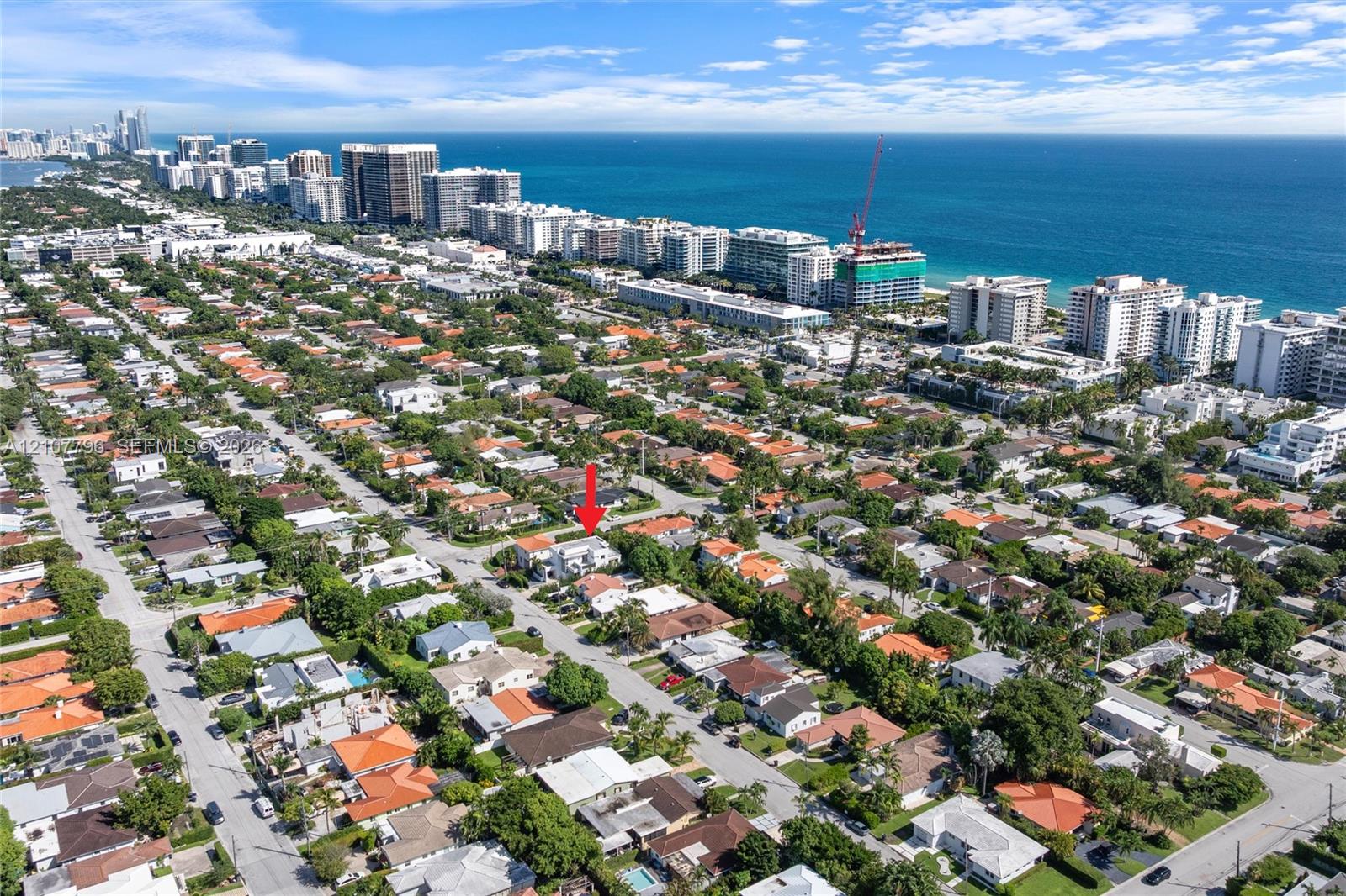 Aerial perspective of a residential property situated in a coastal area, featuring mature landscaping and proximity to the Atlantic Ocean