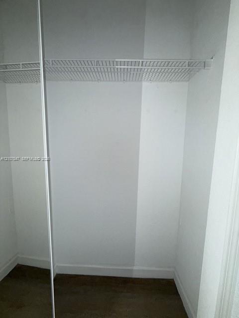 Storage space featuring wood-finish flooring and integrated wire shelving