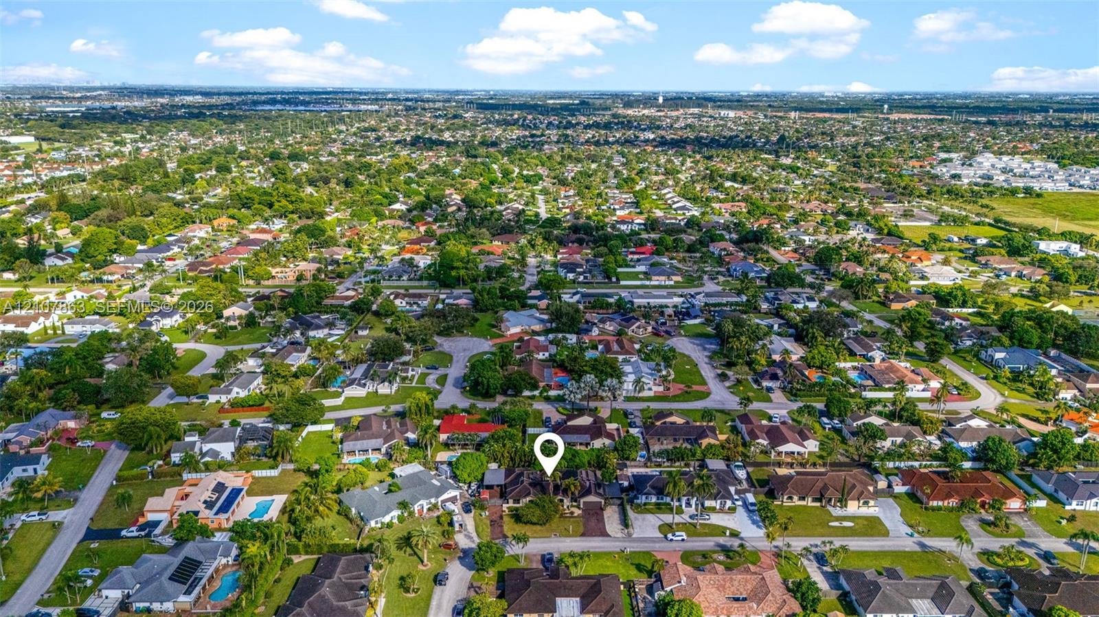 Aerial perspective of a suburban neighborhood featuring mature landscaping and varied residential architecture