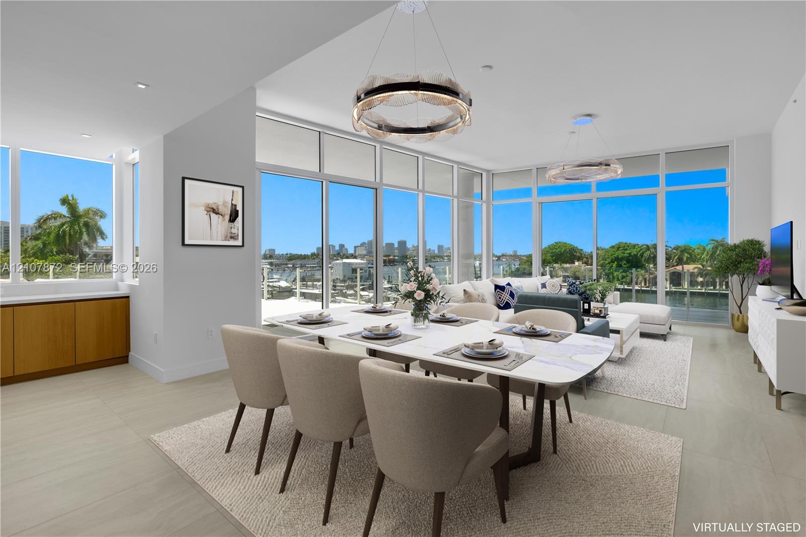 Open-concept living space featuring floor-to-ceiling windows, porcelain tile flooring, built-in lower cabinetry with wood finish, and recessed lighting
