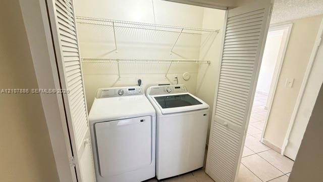 Laundry closet featuring white louvered bifold doors and two tiers of wire shelving