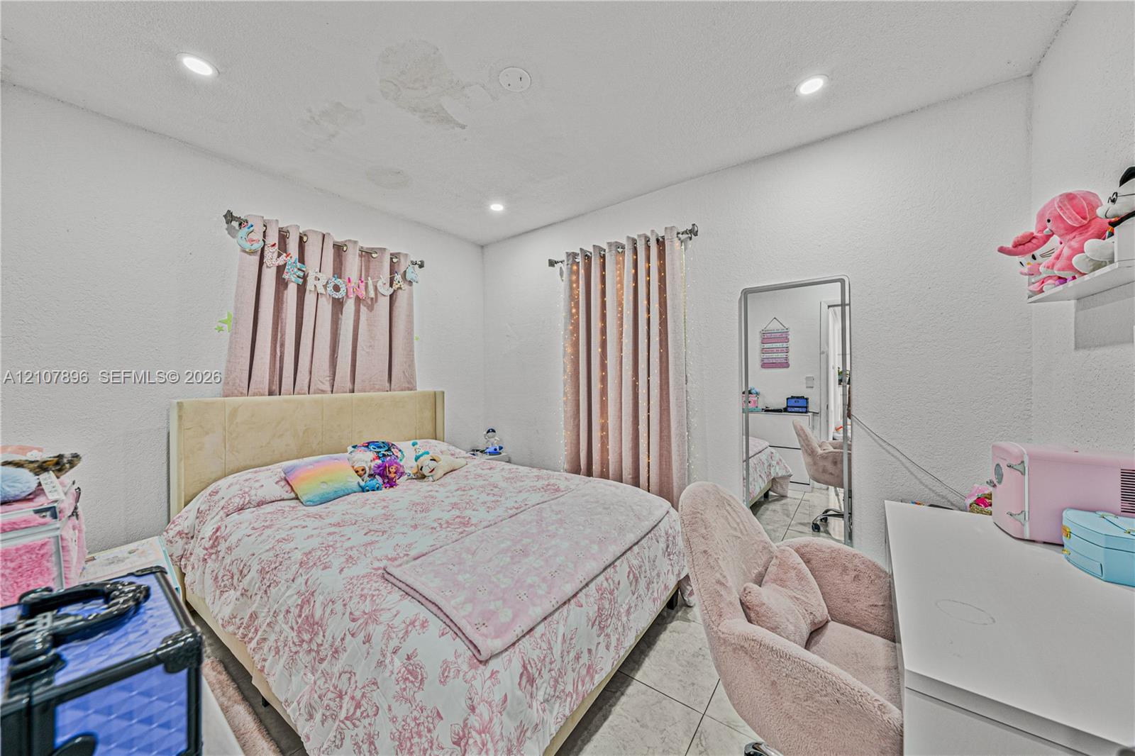 Bedroom featuring tile flooring, recessed lighting, and two windows
