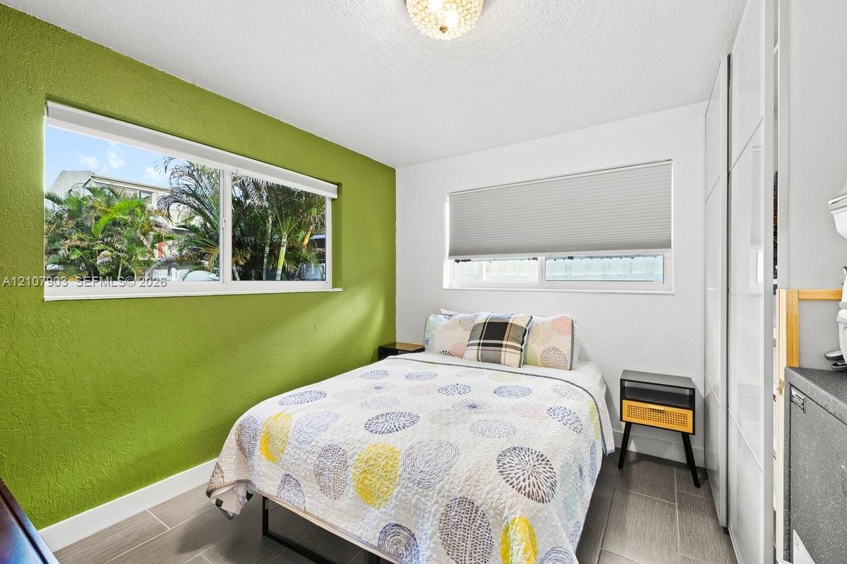 Dual-pane windows, built-in floor-to-ceiling cabinetry, tile flooring, and a flush-mount ceiling light fixture