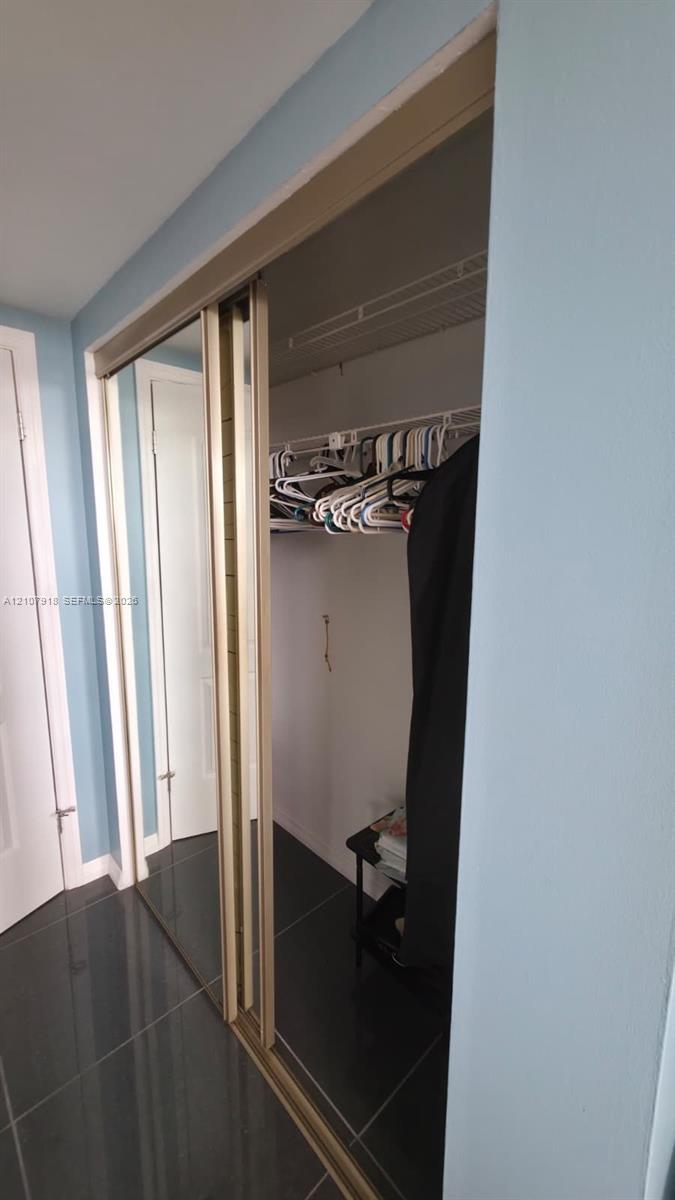 Closet featuring mirrored sliding doors and a white wire shelving system