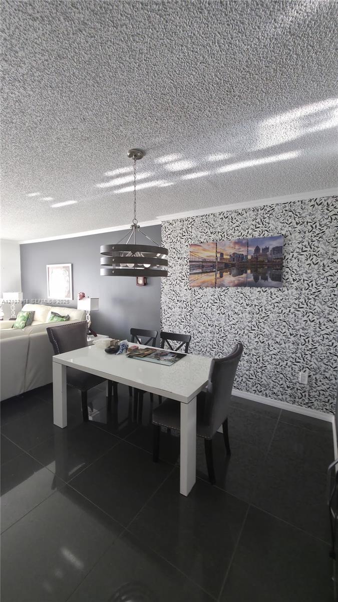 Large-format tile flooring, textured ceiling, decorative patterned wall covering, and a multi-tier pendant light fixture Large-format tile flooring, textured ceiling, decorative patterned wall covering, and a multi-tier pendant light fixture