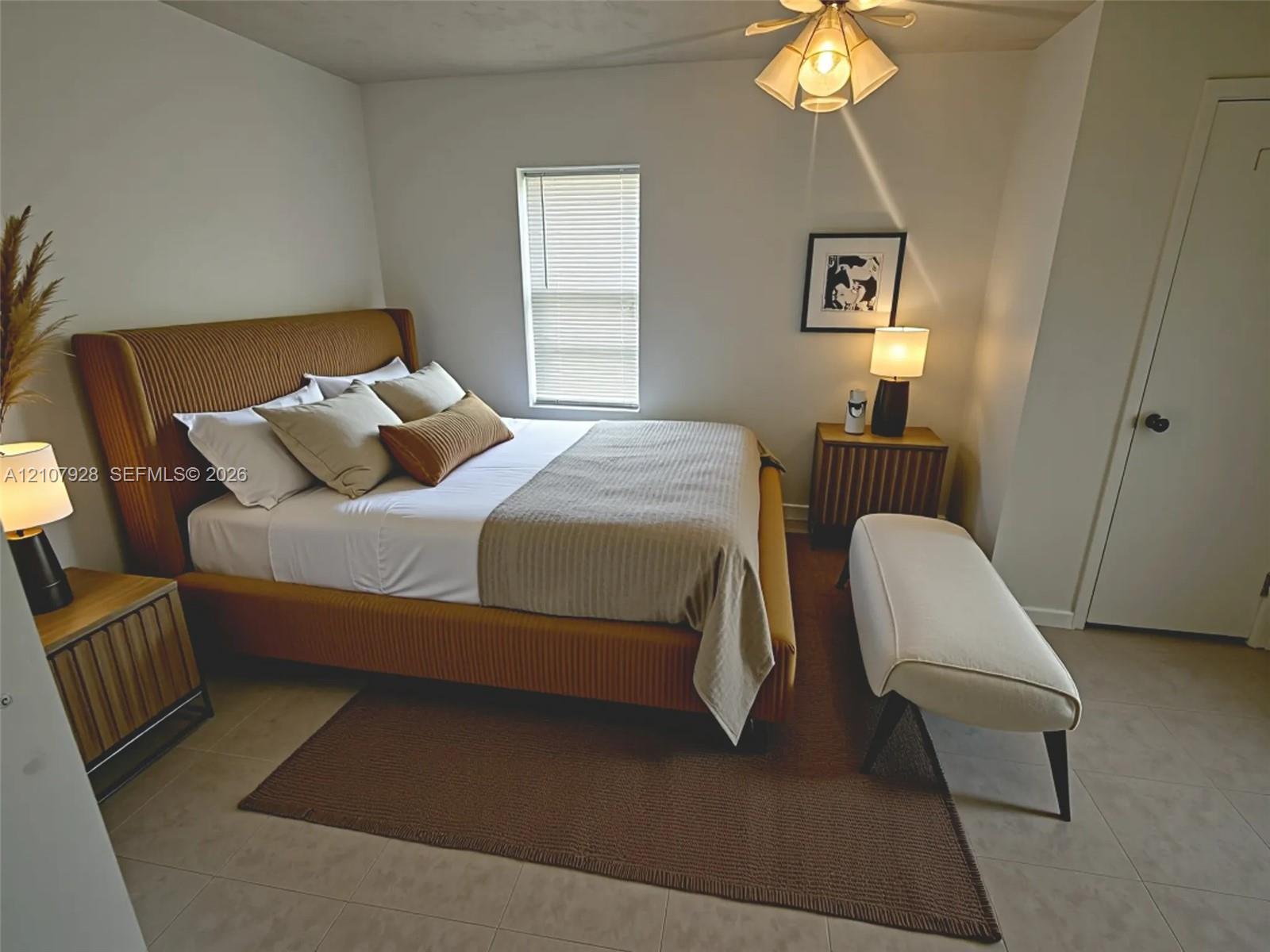 Multi-light ceiling fixture, tiled flooring, and neutral wall tones